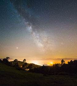 Scenic view of land against sky at night