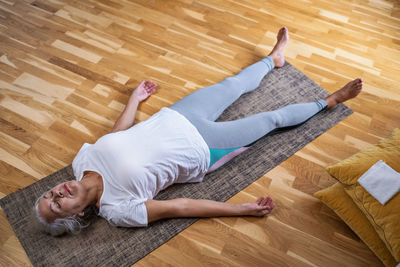 Low section of woman lying on floor