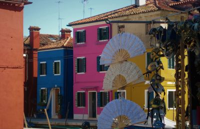 Folding fan decorations hanging against buildings