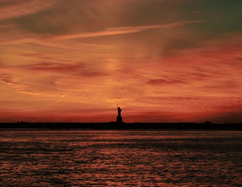 Silhouette of statue at sunset