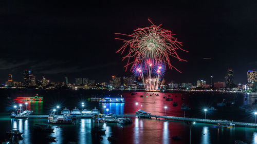 Firework display over river at night