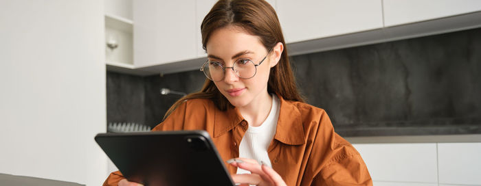 Young man using digital tablet while sitting at home