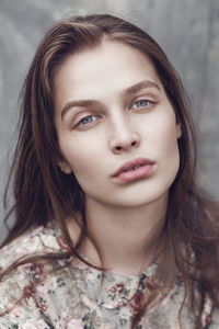 Close-up portrait of young woman with freckles