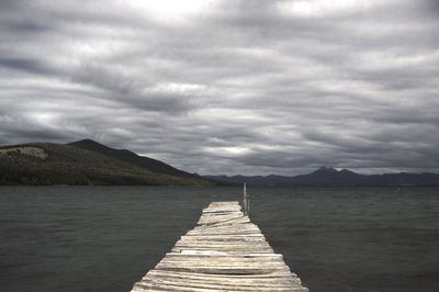 Pier over lake against sky