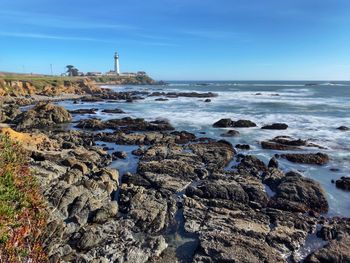 Pigeon point lighthouse landscape from pigeon point bluffs, blue sky, rocky coastline foreground