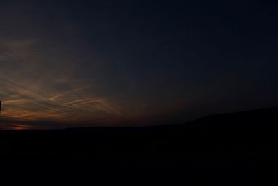 Silhouette landscape against sky during sunset
