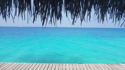 Scenic view of sea against clear blue sky