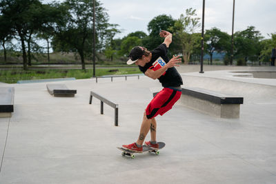 Full length of man skateboarding on skateboard