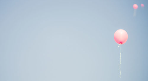 Low angle view of balloons against clear sky