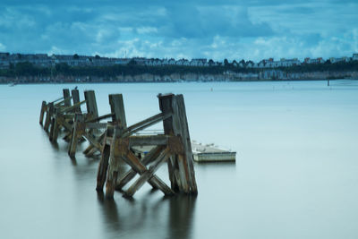 Pier over lake against sky