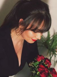 Portrait of woman with red roses