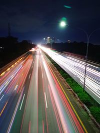 High angle view of light trails on highway at night