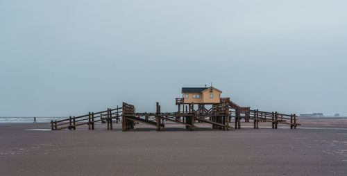 Pier over sea against clear sky