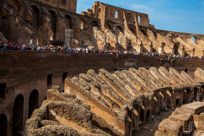 Tourists visiting the interior of the famous colosseum in rome