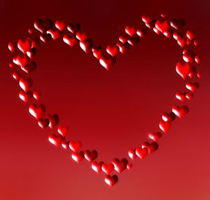 Close-up of heart shape over red background