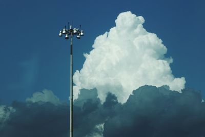 Low angle view of floodlight against blue sky