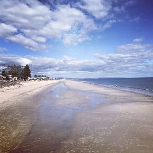 View of beach against cloudy sky