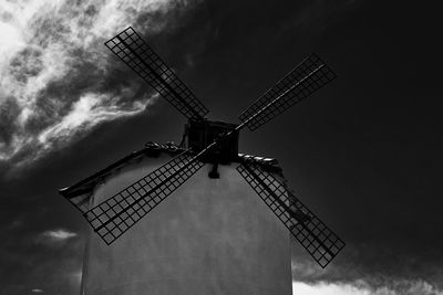 Low angle view of traditional windmill against sky