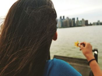 Rear view of young woman looking at city