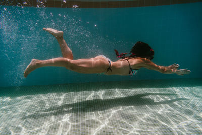 Full length of woman swimming in pool