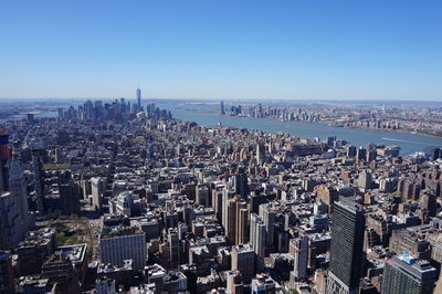 High angle view of cityscape against clear blue sky