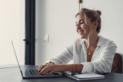 Young woman using laptop at home