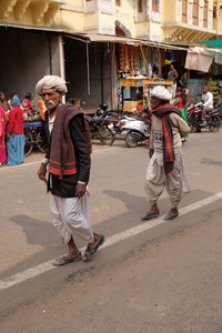 People walking on road in city