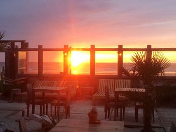 Pier on sea at sunset