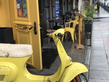 Close-up of yellow car parked on street