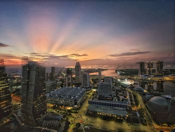 High angle view of illuminated cityscape against sky during sunset