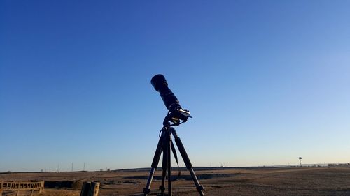 Low angle view of camera on field against clear sky