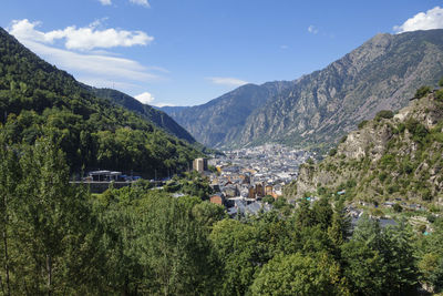 Scenic view of trees and mountains against sky