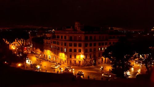 Illuminated cityscape against sky at night