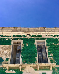 Low angle view of building against blue sky