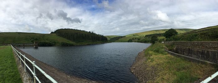 Panoramic view of river against cloudy sky