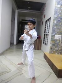 Full length of boy standing in building