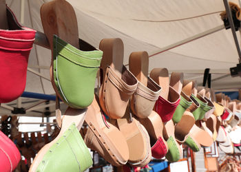 Multi colored shoes for sale at market stall