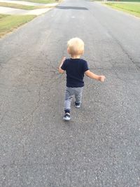 Full length of man walking on road