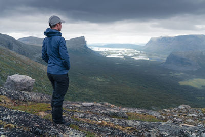 Man standing on mountain against sky