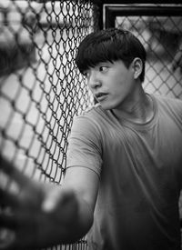 Man looking through fence