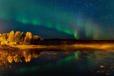 Scenic view of lake against sky at night