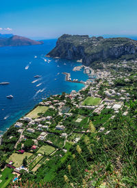High angle view of sea and city against sky