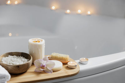 Preparation for hotel spa treatment, home bath procedure. white washbasin in bathroom, accessories
