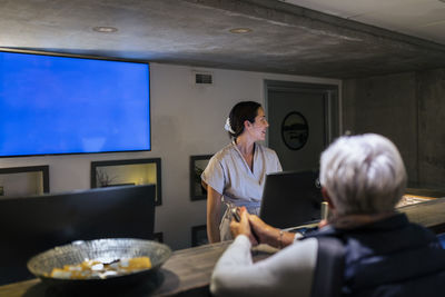 Receptionist assisting customer at health spa