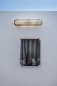 Autoportrait of a young woman in the window. photographer on the ferry