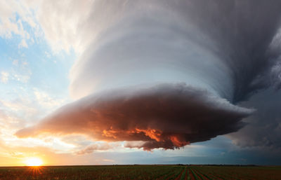 A dramatic supercell storm at sunset over a field near earth, texas