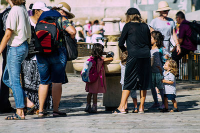 Rear view of people walking on street