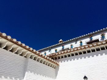 Low angle view of building against clear blue sky