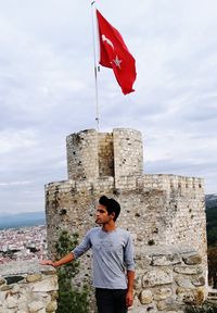 Man standing against flag 