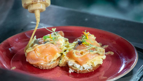 Freshly prepared smoked salmon scrambled eggs toast drizzled with honey mustard dressing close up